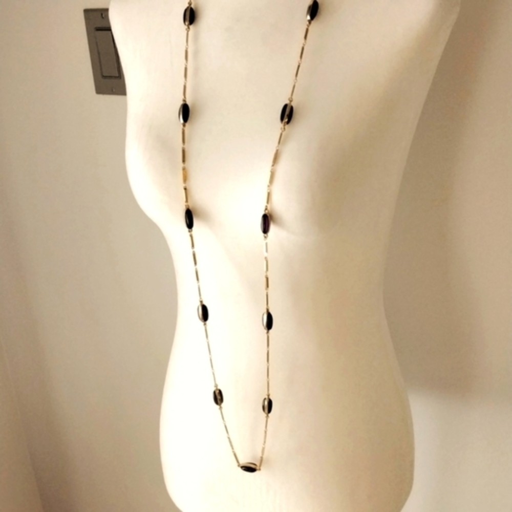 Long chain goldtone necklace with purple gemstones